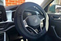 The optional protective steering wheel cover applied to a car