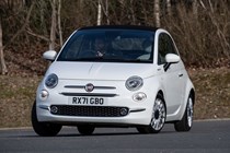 Fiat 500C (2023) review: front cornering, white car, wood in background