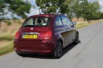 Red Fiat 500 driving tracking rear 2015