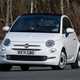 Fiat 500C (2023) review: front cornering, white car, wood in background