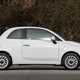Fiat 500C (2023) review: side view static, white car, wood in background