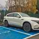 White 2019 Mercedes-Benz EQC front three-quarter on charge