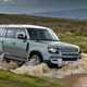 Land Rover Defender (2021) driving through mud