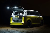 VW ID. Buzz review, rear view with tailgate open, in dark, with lights