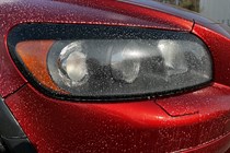 A headlight with pre-wash sprayed onto it