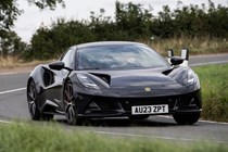 Lotus Emira 2.0-litre (2023): front three quarter cornering, showing (some) body roll, black paint