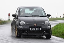 Abarth 695 (2024) review: front three quarter cornering, rain, black paint