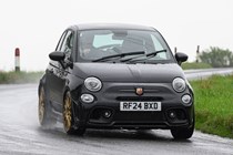 Abarth 695 (2024) review: front three quarter cornering, rain, black paint