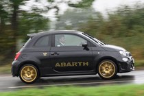 Abarth 695 (2024) review: pan shot right, rain, black paint