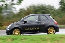 Abarth 695 (2024) review: pan shot left, rain, black paint