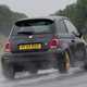 Abarth 695 (2024) review: rear three quarter cornering, rain, black paint