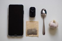 Garmin Dash Cam Mini 2 with items to show scale