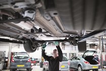 Mechanic checking under car - What is an MOT