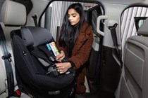 Woman installing child seat - What is Isofix