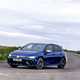 Image of blue Volkswagen Golf R, front left view, driving round corner