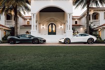 Two Ferraris parked outside a house