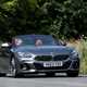 Image of a BMW Z4, in grey, driving round a corner