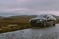 Audi by the side of a rain covered road