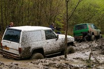 Two off-roaders in muddy terrain