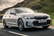 Best estate cars 2024: BMW 3 Series Touring, front three quarter driving, silver paint, British road