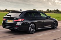 Best estate cars 2024: BMW 5 Series Touring, rear three quarter driving, black paint