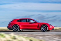 Best estate cars 2024: Porsche Taycan Sport Turismo, side view driving, red paint, British road