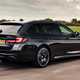 Best estate cars 2024: BMW 5 Series Touring, rear three quarter driving, black paint