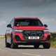 The best seven-seaters in 2025: Audi Q7, front three quarter cornering, red paint