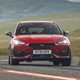 Best cheap fast cars in 2024: Cupra Leon, front three quarter cornering, red paint