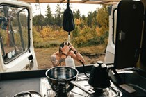 image of a man taking a shower at the back of a campervan