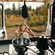 image of a man taking a shower at the back of a campervan