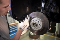 Mechanic checking car brakes - What is a car service