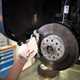 Mechanic checking car brakes - What is a car service