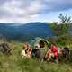 Family enjoying eating when trekking with tent in mountains