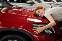 Woman hugging car - How to spot a clocked car