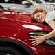 Woman hugging car - How to spot a clocked car