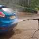 The first stage of a cleaning a car is to hose off the loose dirt.