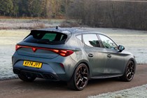 Cupra Leon (2025) review: rear three quarter driving, matte grey paint