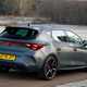 Cupra Leon (2025) review: rear three quarter driving, matte grey paint