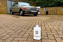 The bottle of Autoglym Ceramic car shampoo next to a car