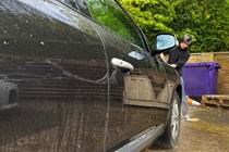 Water sheeting from a black car