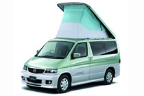 Image of Mazda Bongo Friendee in green and white, static front three-quarters view with pop-top lifted