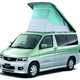 Image of Mazda Bongo Friendee in green and white, static front three-quarters view with pop-top lifted