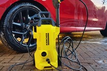 Karcher K2 on test next to a red car