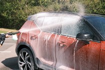 Pressure washer spraying car