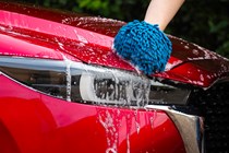 A red car washed with Autoglym UHD Shampoo