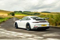 Porsche 911 GT3 review - white, rear, driving round corner