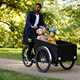 a man and two children in a cargo bike