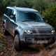 Land Rover Defender 130 V8 review: front three quarter off-roading, black paint
