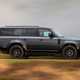Land Rover Defender 130 V8 review: side view driving, British B-road, black paint